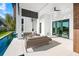 Spacious patio with cozy lounge area, ideal for entertaining guests and enjoying outdoor living at 100 6Th S St, Bradenton Beach, FL 34217