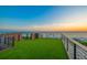 Stunning rooftop deck with artificial turf, offering panoramic ocean views and beach access at 100 6Th S St, Bradenton Beach, FL 34217