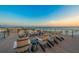 Rooftop deck with comfortable lounge chairs overlooking the beach and the ocean at 100 6Th S St, Bradenton Beach, FL 34217