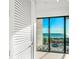 Bright view from inside features the beach and ocean through a large sliding glass door at 100 6Th S St, Bradenton Beach, FL 34217