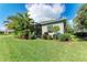 Beautiful backyard featuring a screened lanai, lush landscaping, and well-maintained lawn at 1219 Thornbury Dr, Parrish, FL 34219