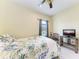 Well-lit bedroom with decorative bedspread, comfortable chair, and a TV for relaxation at 1219 Thornbury Dr, Parrish, FL 34219