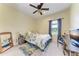 Cozy bedroom with a floral comforter, blue curtains, and lots of natural light at 1219 Thornbury Dr, Parrish, FL 34219