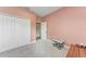 Cozy bedroom with pink walls, carpet flooring, a closet, and a small stool at 1219 Thornbury Dr, Parrish, FL 34219