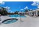 Beautiful community pool and hot tub, surrounded by lounge chairs and palm trees for relaxation at 1219 Thornbury Dr, Parrish, FL 34219