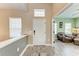 Inviting entryway with tiled floors, neutral walls, and a view into a sunlit living room at 1219 Thornbury Dr, Parrish, FL 34219
