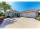 Beautiful single-story home with a well-maintained lawn, lush landscaping, and a three-car garage at 1219 Thornbury Dr, Parrish, FL 34219
