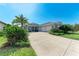 Charming single-story home with lush landscaping, a well-manicured lawn, and a three-car garage at 1219 Thornbury Dr, Parrish, FL 34219