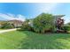Lush green lawn and tropical landscaping surround this charming home with a well-maintained front yard at 1219 Thornbury Dr, Parrish, FL 34219