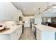 Stylish white kitchen features long countertops and an island with seating and stainless steel appliances at 1219 Thornbury Dr, Parrish, FL 34219