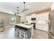 Modern kitchen featuring sleek white cabinetry, stainless steel appliances, and a large center island at 1219 Thornbury Dr, Parrish, FL 34219