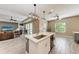 Bright open kitchen featuring a spacious island with stone countertops, stainless steel appliances, and a view into the living area at 1219 Thornbury Dr, Parrish, FL 34219