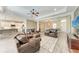Open-concept living room adjacent to a modern kitchen, with comfortable seating and ample natural light at 1219 Thornbury Dr, Parrish, FL 34219