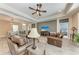 Inviting living room with seamless flow to dining area and kitchen, features modern decor and finishes at 1219 Thornbury Dr, Parrish, FL 34219
