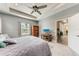Spacious main bedroom with tray ceiling, ceiling fan, and a TV on a wooden stand, offering a relaxing retreat at 1219 Thornbury Dr, Parrish, FL 34219