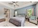 Comfortable main bedroom featuring tray ceiling, ceiling fan, natural light, and space for a seating area at 1219 Thornbury Dr, Parrish, FL 34219