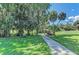 Scenic park with mature trees, picnic tables, and a paved path, perfect for outdoor activities at 1219 Thornbury Dr, Parrish, FL 34219