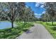 Scenic paved path next to a lake, lined with trees in a beautiful community setting at 1219 Thornbury Dr, Parrish, FL 34219
