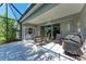 Comfortable screened-in patio with dining set, BBQ grill, and swing, perfect for outdoor enjoyment at 1219 Thornbury Dr, Parrish, FL 34219