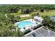 Aerial view of a resort-style pool, clubhouse, volleyball court, and ample parking at 1219 Thornbury Dr, Parrish, FL 34219
