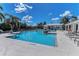 Large community pool with clear blue water, lounge chairs, and palm trees for a resort-like experience at 1219 Thornbury Dr, Parrish, FL 34219