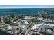 This aerial view showcases an idyllic coastal town with lush landscaping, water views and convenient access to the beach at 130 N Adams Dr, Sarasota, FL 34236