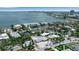 Aerial view of a waterfront neighborhood featuring lush greenery, beautiful homes, and scenic bay views at 130 N Adams Dr, Sarasota, FL 34236
