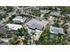 Aerial view of home showcasing its well-maintained yard, driveway, and nearby palm trees at 130 N Adams Dr, Sarasota, FL 34236