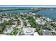 Aerial view of a residential area near a scenic bay, featuring lush greenery and attractive homes at 130 N Adams Dr, Sarasota, FL 34236
