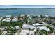 Aerial view of a single-story home in a waterfront community with lush landscaping and nearby bay views at 130 N Adams Dr, Sarasota, FL 34236