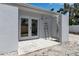 Outdoor patio with a private shower and convenient access to the home's interior through double doors at 130 N Adams Dr, Sarasota, FL 34236