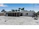 Open backyard with palm trees, a chair swing and gravel landscaping at 130 N Adams Dr, Sarasota, FL 34236
