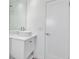 Modern bathroom featuring a vessel sink with mirror and white vanity and door at 130 N Adams Dr, Sarasota, FL 34236