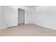 Bright bedroom featuring white walls, closet with bi-fold doors and neutral carpet at 130 N Adams Dr, Sarasota, FL 34236