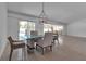 Elegant dining room boasts modern chandelier, sliders to patio, and plenty of space at 130 N Adams Dr, Sarasota, FL 34236