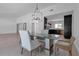 Dining room featuring modern lighting and access to the kitchen and living area at 130 N Adams Dr, Sarasota, FL 34236