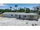 Charming single-story home with a clean design, complemented by tropical landscaping and a well-maintained front yard at 130 N Adams Dr, Sarasota, FL 34236
