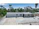 Charming single-story home with a well-maintained exterior, attached garage, and lush tropical landscaping at 130 N Adams Dr, Sarasota, FL 34236