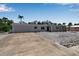 Charming single-story home with a garage and a concrete driveway, enhanced by a unique stone landscape at 130 N Adams Dr, Sarasota, FL 34236