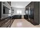 Sleek kitchen with dark cabinets, stainless steel oven, and built-in wine fridge at 130 N Adams Dr, Sarasota, FL 34236