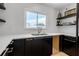 Bright kitchen sink area with modern fixtures and an open window view at 130 N Adams Dr, Sarasota, FL 34236