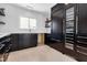 Kitchen with dark cabinets, modern appliances, floating shelves and a built-in wine fridge at 130 N Adams Dr, Sarasota, FL 34236