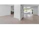Bright living area featuring terrazzo floors and a view of the dining area with sliding glass doors at 130 N Adams Dr, Sarasota, FL 34236