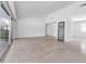 Empty living room with terrazzo floors, white walls, and ample natural light at 130 N Adams Dr, Sarasota, FL 34236