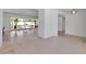 Expansive living room featuring terrazzo flooring, open space, and light-filled windows at 130 N Adams Dr, Sarasota, FL 34236