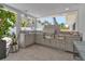 Outdoor kitchen area with modern appliances and a view of the backyard at 130 N Adams Dr, Sarasota, FL 34236