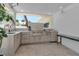 Outdoor kitchen featuring stainless steel grill, cabinetry, sink and views to the yard at 130 N Adams Dr, Sarasota, FL 34236
