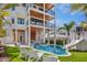 Stunning backyard featuring a pool, spa, and multiple outdoor lounging areas at 135 Avenida Veneccia, Sarasota, FL 34242