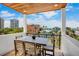 Balcony with a wood ceiling, black railing and views of the neighborhood and ocean at 135 Avenida Veneccia, Sarasota, FL 34242