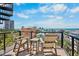 Balcony with seating, offering stunning ocean views and city skyline at 135 Avenida Veneccia, Sarasota, FL 34242